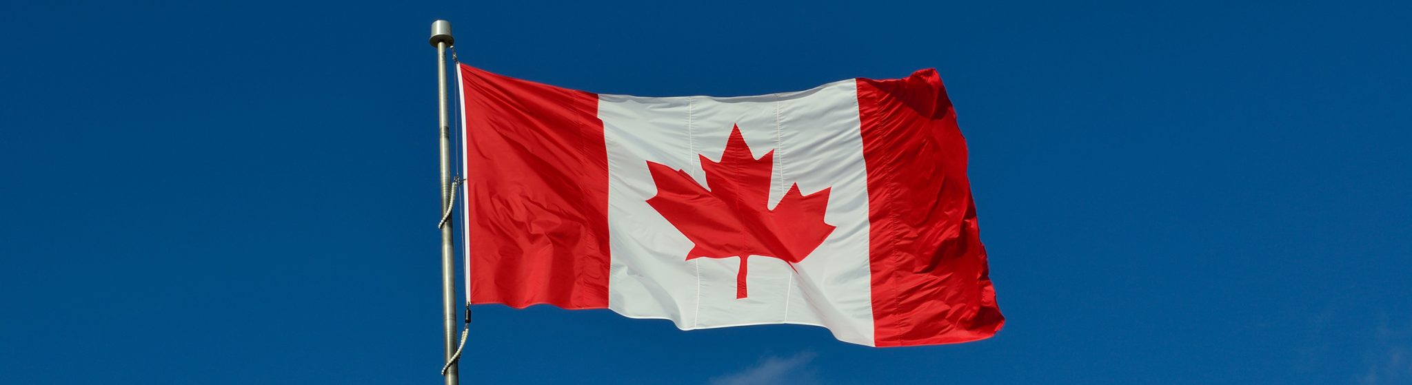 a Canadian flag blowing in the wind